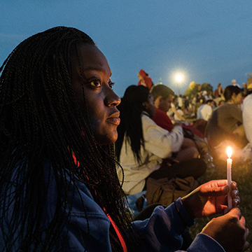 lighting a candle at youth festival in Poland